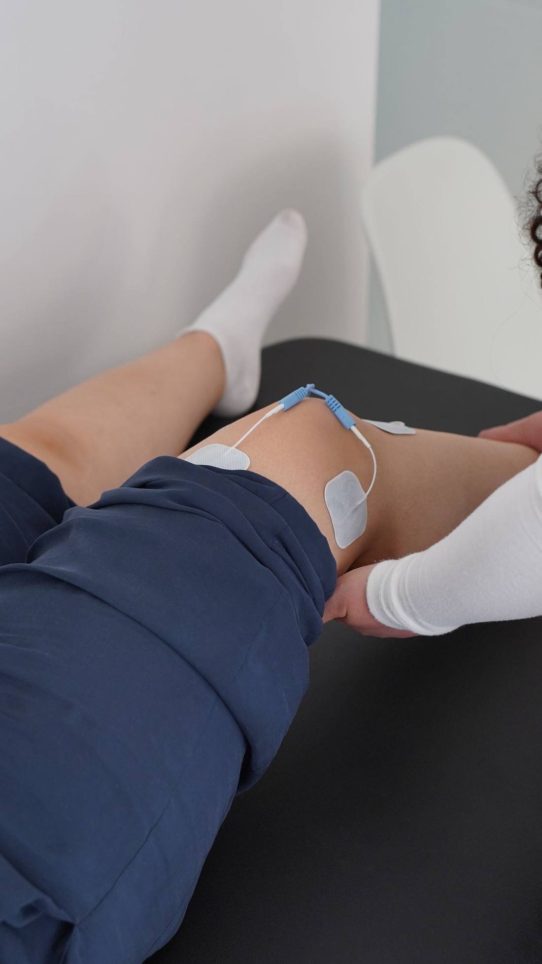 Physiotherapist guiding a patient through a knee recovery session